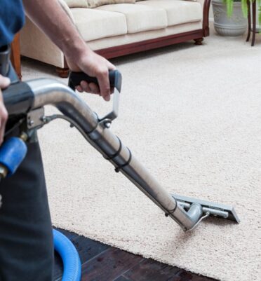 man cleaning carpet